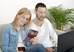 Young couple preparing vacation trip with passport