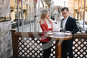 Young couple of professionals chatting during a coffee break