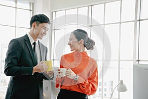 Young couple of professionals chatting during coffee break