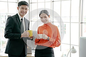 Young couple of professionals chatting during a coffee break