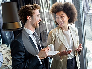 Young couple of professionals chatting during a coffee break