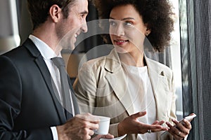 Young couple of professionals chatting during a coffee break