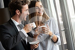 Young couple of professionals chatting during a coffee break