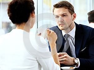 Young couple of professionals chatting during coffee break