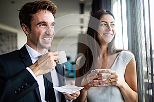 Young couple of professionals chatting during a coffee break