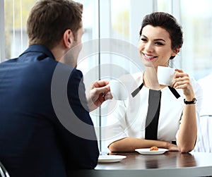 Young couple of professionals chatting during a coffeebreak