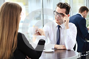 Young couple of professionals chatting during a coffeebreak