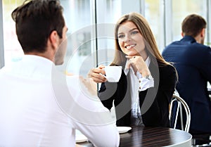 Young couple of professionals chatting during a coffeebreak