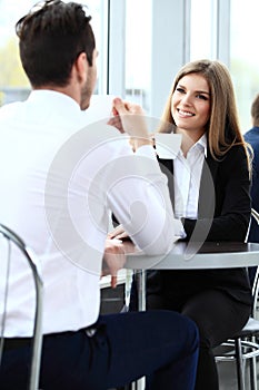 Young couple of professionals chatting during a coffeebreak