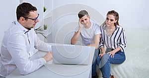 Young couple at psychologist cabinet. Sad male patient talking about his problems. Young female patient.