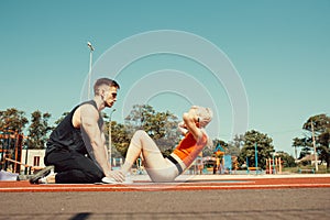 Young couple pump abdominal muscles on yoga mat