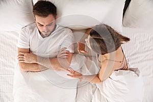 Young couple quarreling in bed at home. Relationship problems