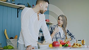 Young couple quarrels in the kitchen at home
