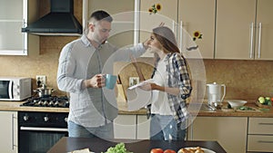 Young couple quarrels in the kitchen at home