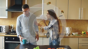 Young couple quarrels in the kitchen at home