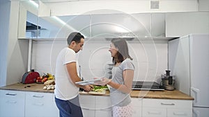 Young Couple Quarrels in the Kitchen. Man and Woman Scream in Frustration and Angrily Gesticulate. slow motion