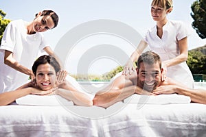 Young couple receiving a back massage from masseur