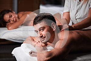 Young couple receiving a back massage in a Spa center