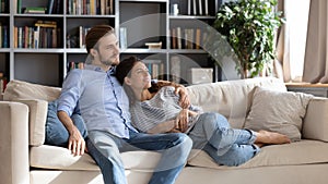 Young couple relax on comfortable couch at home