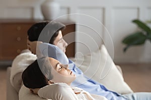 Young couple relax on couch breathing fresh air