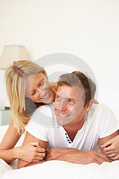 Young Couple Relaxing On Bed