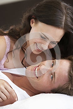 Young Couple Relaxing On Bed