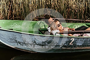 young couple relaxing in boat on