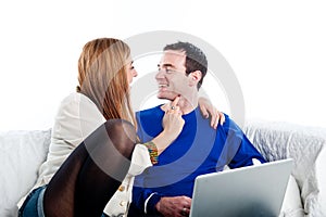 Young couple relaxing on the couch with laptop