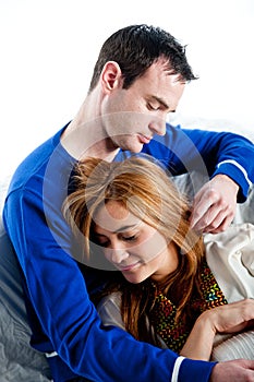 Young couple relaxing and cuddling together on the sofa