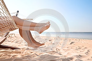 Young couple relaxing in hammock on beach