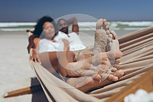 Young couple relaxing on hammock at beach