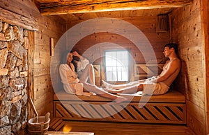 Young couple relaxing in a hot sauna