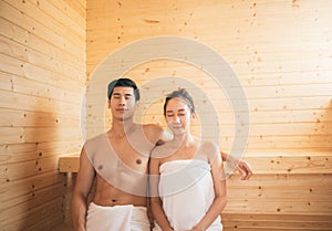 Young couple relaxing inside a sauna