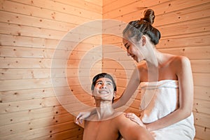 Young couple relaxing inside a sauna