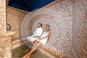 Young couple relaxing inside spa sauna turkish bath - Two lovers enjoying vacation in luxury resort hotel