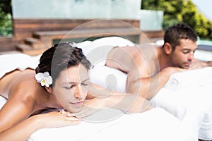 Young couple relaxing on massage table