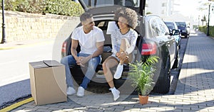 Young couple relaxing while moving house