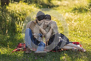 young couple looking at photos on a camera