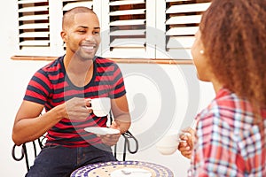 Young Couple Relaxing Outdoors And Drinking Coffee