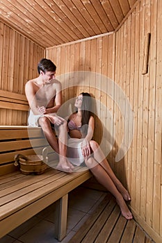 Young couple relaxing in the sauna