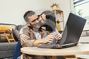 Couple relaxing on sofa with laptop.Love,happiness,people and fun concept