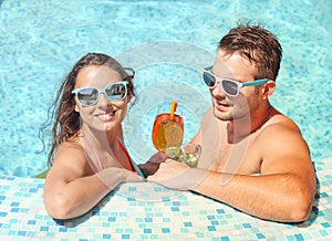 Young couple are relaxing in swimming pool