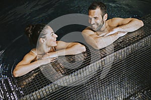 Young couple relaxing in a swimming pool