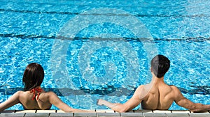 Young Couple relaxing in swimming pool