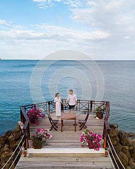 young couple relaxing at a wooden pier in ocean, Saint Lucia, luxury holiday Saint Lucia Caribbean