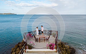 young couple relaxing at a wooden pier in ocean, Saint Lucia, luxury holiday Saint Lucia Caribbean