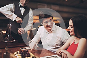 Young couple in restaurant. Handsome man and woman on date in restaurant.