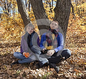 Young couple resting in autumn forest