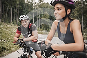 Young Couple Riding on Bicycles at Forest Road.