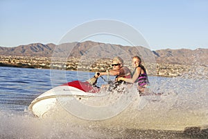 Young Couple Riding PWC